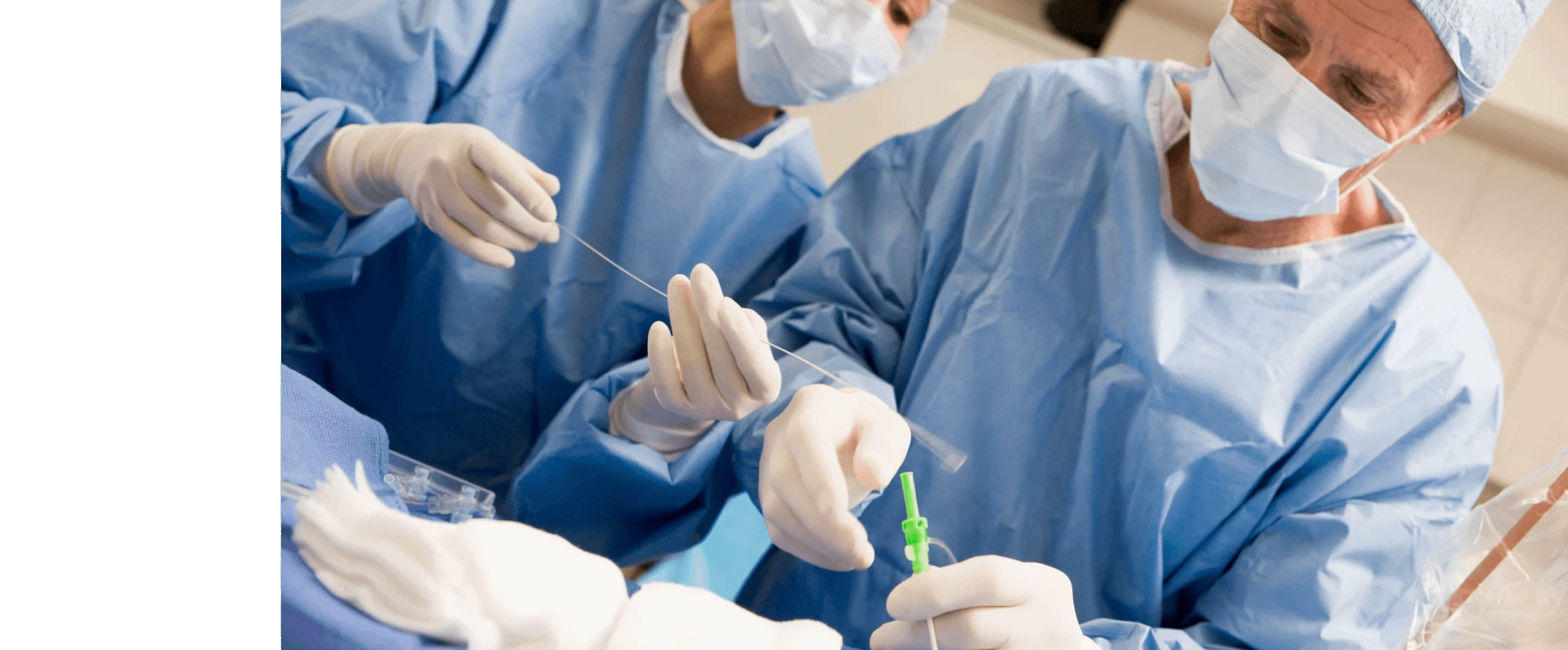 Physician looking at monitors in operating room